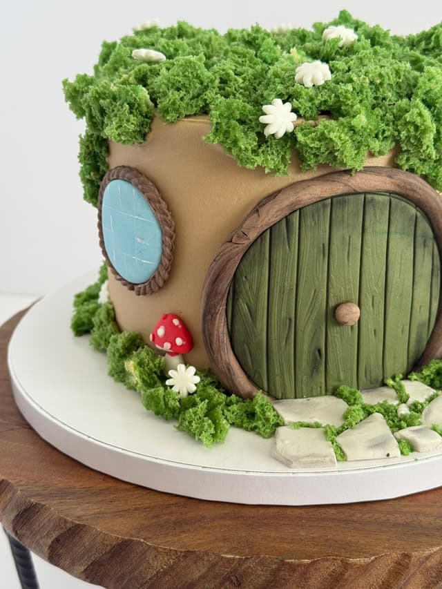 Hobbit hole cake with green door and moss